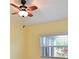Bedroom with ceiling fan and natural light streaming through the window at 5910 Majestic Way, Palmetto, FL 34221