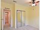 Bright bedroom with neutral carpet, a ceiling fan, and closet with mirrored sliding doors at 5910 Majestic Way, Palmetto, FL 34221