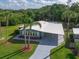 Inviting home with a covered carport, mature landscaping, and beautiful green lawn at 5910 Majestic Way, Palmetto, FL 34221