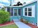 Corner of home exterior with a trimmed green bush and mulched flower bed at 5910 Majestic Way, Palmetto, FL 34221