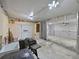 Large garage with ample lighting, grill, storage space and access to other spaces at 5910 Majestic Way, Palmetto, FL 34221