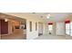Open living space with a ceiling fan, neutral carpeting, and multiple windows for natural light at 5910 Majestic Way, Palmetto, FL 34221