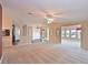 Open living area with plush carpeting, neutral walls, and a clear view into other living spaces at 5910 Majestic Way, Palmetto, FL 34221