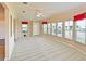 Bright living room featuring a ceiling fan, plush carpeting, and large windows at 5910 Majestic Way, Palmetto, FL 34221