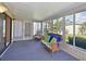 Sunroom with a wicker sofa, ceiling fan, and walls of windows at 5910 Majestic Way, Palmetto, FL 34221