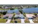 Aerial view of a home on the water with a private dock and screened in pool in the backyard at 6387 Shalimar St, Port Charlotte, FL 33981
