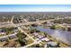 Aerial view of a lakeside neighborhood featuring multiple homes and a highway in the distance at 6387 Shalimar St, Port Charlotte, FL 33981