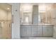 Bathroom featuring a walk-in shower and double vanity with lots of storage at 6387 Shalimar St, Port Charlotte, FL 33981
