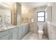 Bathroom with a double vanity, stone countertops, and neutral colors at 6387 Shalimar St, Port Charlotte, FL 33981