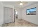 Bright bedroom featuring tile flooring, ceiling fan, closet, and an ensuite bathroom at 6387 Shalimar St, Port Charlotte, FL 33981