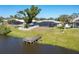 Waterfront home featuring a screened-in pool and dock, perfect for enjoying outdoor living at 6387 Shalimar St, Port Charlotte, FL 33981
