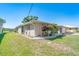 Well-maintained single-story home with lush landscaping and an attached garage, next to a waterway at 6387 Shalimar St, Port Charlotte, FL 33981