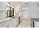 Modern kitchen with white cabinetry, stainless appliances, granite counters, and a view to the pool and outdoor area at 6387 Shalimar St, Port Charlotte, FL 33981