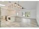 Spacious kitchen featuring stainless steel appliances, an island, and modern lighting, seamlessly connected to the living area at 6387 Shalimar St, Port Charlotte, FL 33981