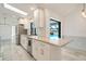 Modern kitchen with white cabinetry, granite countertops, stainless steel appliances, and a view of the pool at 6387 Shalimar St, Port Charlotte, FL 33981
