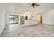 Bright, open kitchen and living area with stainless steel appliances and access to the outdoor pool area at 6387 Shalimar St, Port Charlotte, FL 33981