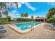 Community pool area featuring lounge chairs, lush landscaping, and a beautiful patio at 6660 Schooner Bay Cir # 6660, Sarasota, FL 34231