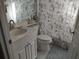 Charming bathroom featuring a toilet, sink, vanity, mirror, and decorative shower curtain at 6821 Fairview Ter # 6821, Bradenton, FL 34203