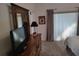 Bright bedroom featuring neutral carpeting, stylish curtains, and a dark wood dresser at 6821 Fairview Ter # 6821, Bradenton, FL 34203