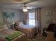 Cozy bedroom featuring two twin beds, ceiling fan, window, and comfortable furnishings at 6821 Fairview Ter # 6821, Bradenton, FL 34203