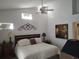 Serene bedroom featuring a queen-size bed, high ceilings, and stylish decor at 6821 Fairview Ter # 6821, Bradenton, FL 34203