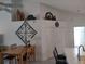 Open-concept dining area featuring a wood table, comfortable seating, and stylish decor on the upper shelf at 6821 Fairview Ter # 6821, Bradenton, FL 34203
