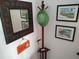 Charming entryway featuring a decorative mirror, coat rack, and coastal-themed artwork at 6821 Fairview Ter # 6821, Bradenton, FL 34203