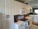 Spacious kitchen with white cabinetry, modern appliances, and an island cooktop for convenient meal preparation at 6821 Fairview Ter # 6821, Bradenton, FL 34203