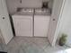 Convenient laundry area with a full-size washer and dryer, plus extra storage and a tiled floor at 6821 Fairview Ter # 6821, Bradenton, FL 34203