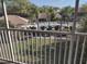 Balcony view featuring the community pool surrounded by palm trees at 6821 Fairview Ter # 6821, Bradenton, FL 34203