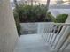 Exterior stairway with white railings and view of lush landscaping at 6821 Fairview Ter # 6821, Bradenton, FL 34203