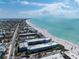 Wide aerial view of the condo community along the beach showing its proximity to other condos and the ocean at 7000 Gulf Dr # 215, Holmes Beach, FL 34217