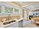 Modern kitchen features stainless steel appliances, white cabinetry, and an adjacent dining area at 709 Fern, Anna Maria, FL 34216