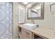 Bathroom featuring a sink, shower, decorative mirror and cabinet at 7122 11Th W Ave, Bradenton, FL 34209