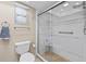 Bright bathroom featuring a glass shower enclosure, toilet, and towel rack at 7122 11Th W Ave, Bradenton, FL 34209