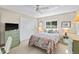 Comfortable bedroom with a ceiling fan, window, dresser, and a comfortable bed at 7122 11Th W Ave, Bradenton, FL 34209