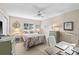 Cozy bedroom with a ceiling fan, mirror, desk and a comfortable bed at 7122 11Th W Ave, Bradenton, FL 34209