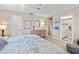 Bright bedroom featuring a ceiling fan, a decorative dresser and mirror, with connecting bath access at 7122 11Th W Ave, Bradenton, FL 34209