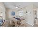 Bright dining room with rustic wood table, bench seating, and modern ceiling fan at 7122 11Th W Ave, Bradenton, FL 34209
