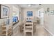 Open dining area with wood floors, view of living room and an abundance of light at 7122 11Th W Ave, Bradenton, FL 34209
