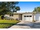 Inviting single-story home with a lush green lawn and a double garage at 7122 11Th W Ave, Bradenton, FL 34209