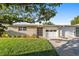 Inviting single-story home with a lush green lawn and a double garage at 7122 11Th W Ave, Bradenton, FL 34209