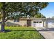 Charming single-story home with a well-manicured lawn and a covered front entrance at 7122 11Th W Ave, Bradenton, FL 34209