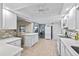 Modern kitchen with new white cabinets, breakfast bar, updated appliances and modern backsplash at 7122 11Th W Ave, Bradenton, FL 34209