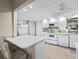 Bright, updated kitchen with white cabinets, modern appliances, and breakfast bar seating at 7122 11Th W Ave, Bradenton, FL 34209