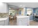 Bright kitchen with tile floor open to a dining area and featuring a functional center island at 7122 11Th W Ave, Bradenton, FL 34209