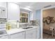 Well-lit kitchen with white cabinetry, stylish backsplash, and modern sink with ample counter space at 7122 11Th W Ave, Bradenton, FL 34209