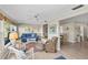Living room with neutral colors featuring cozy seating and views into adjacent dining area at 7122 11Th W Ave, Bradenton, FL 34209