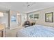 Neutral primary bedroom with a ceiling fan, ensuite bath, and multiple windows at 7122 11Th W Ave, Bradenton, FL 34209
