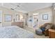 Neutral primary bedroom with a ceiling fan, ensuite bath, and warm natural light at 7122 11Th W Ave, Bradenton, FL 34209